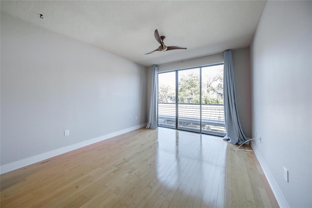 4414 Cedar Springs Road, Unit 214 Dallas, TX 75219 - Photo 9 of 29 Empty room featuring light wood-style floors and ceiling fan