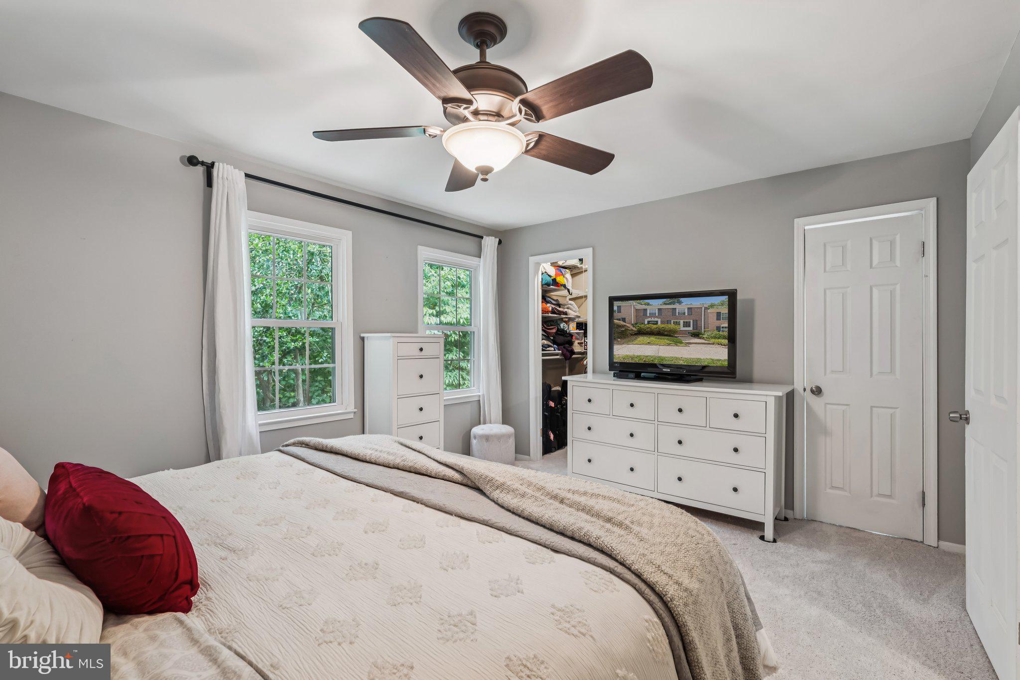 2408 Wanda Way Reston, VA 20191 - Photo 13 of 45 a bedroom with a large bed and a flat screen tv