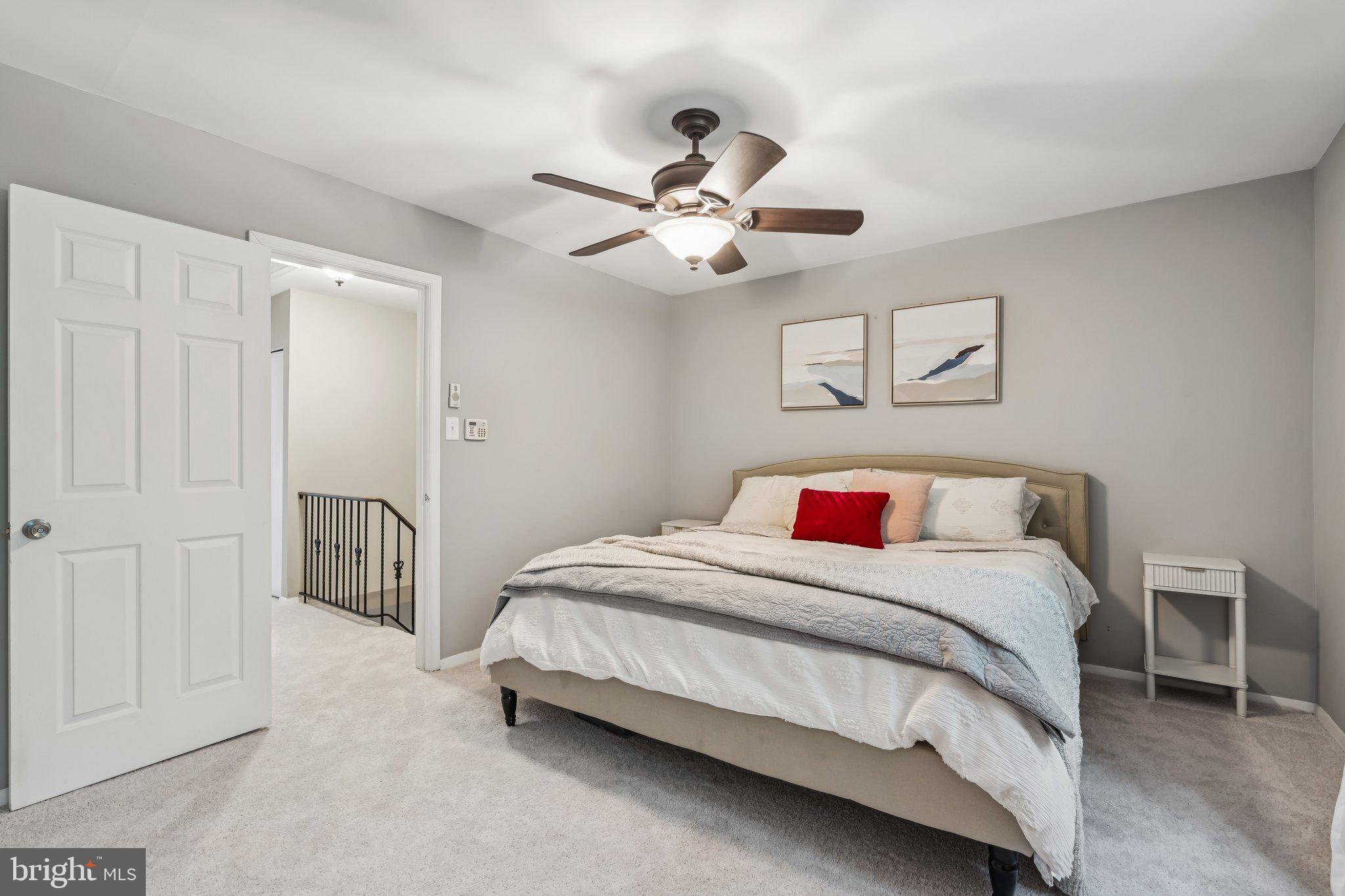 2408 Wanda Way Reston, VA 20191 - Photo 14 of 45 a bedroom with a bed and a chandelier