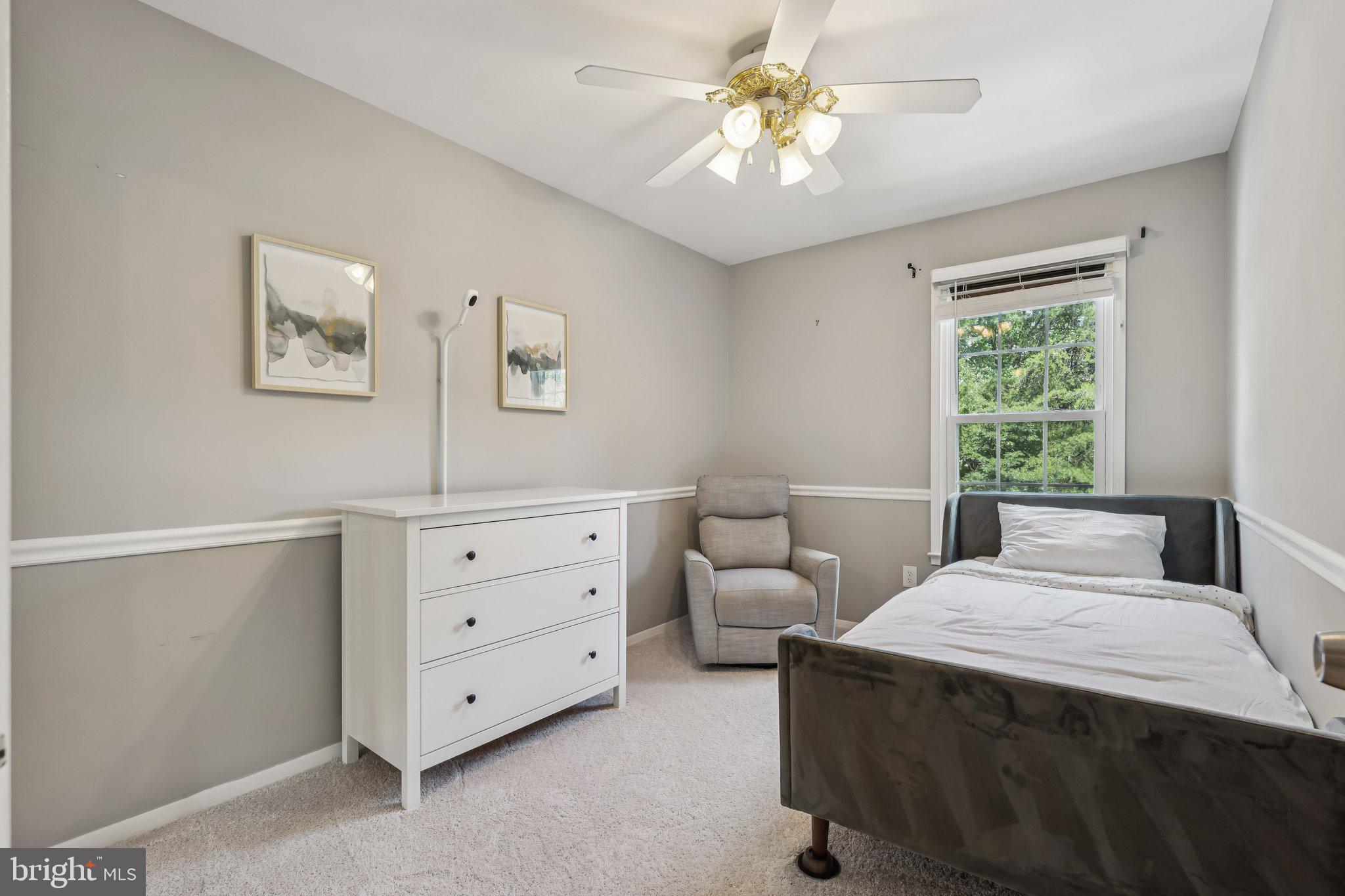 2408 Wanda Way Reston, VA 20191 - Photo 20 of 45 a bedroom with a bed and a chandelier