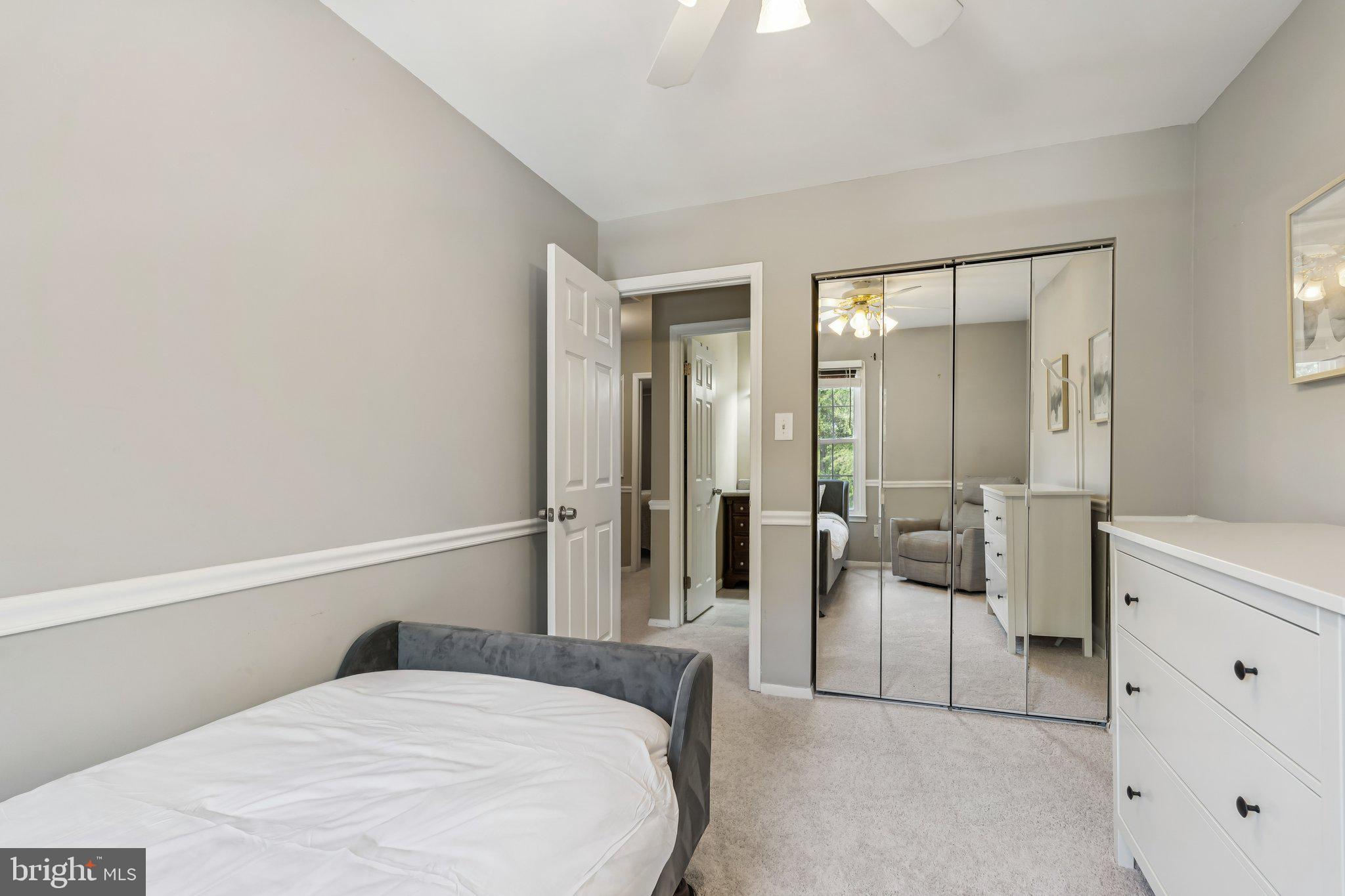 2408 Wanda Way Reston, VA 20191 - Photo 21 of 45 a bedroom with a bed and a couch