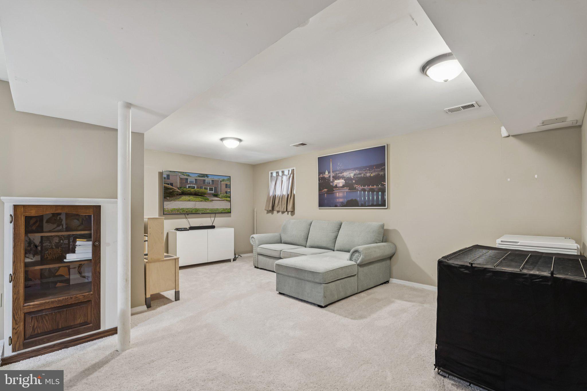 2408 Wanda Way Reston, VA 20191 - Photo 23 of 45 a living room with furniture and a flat screen tv