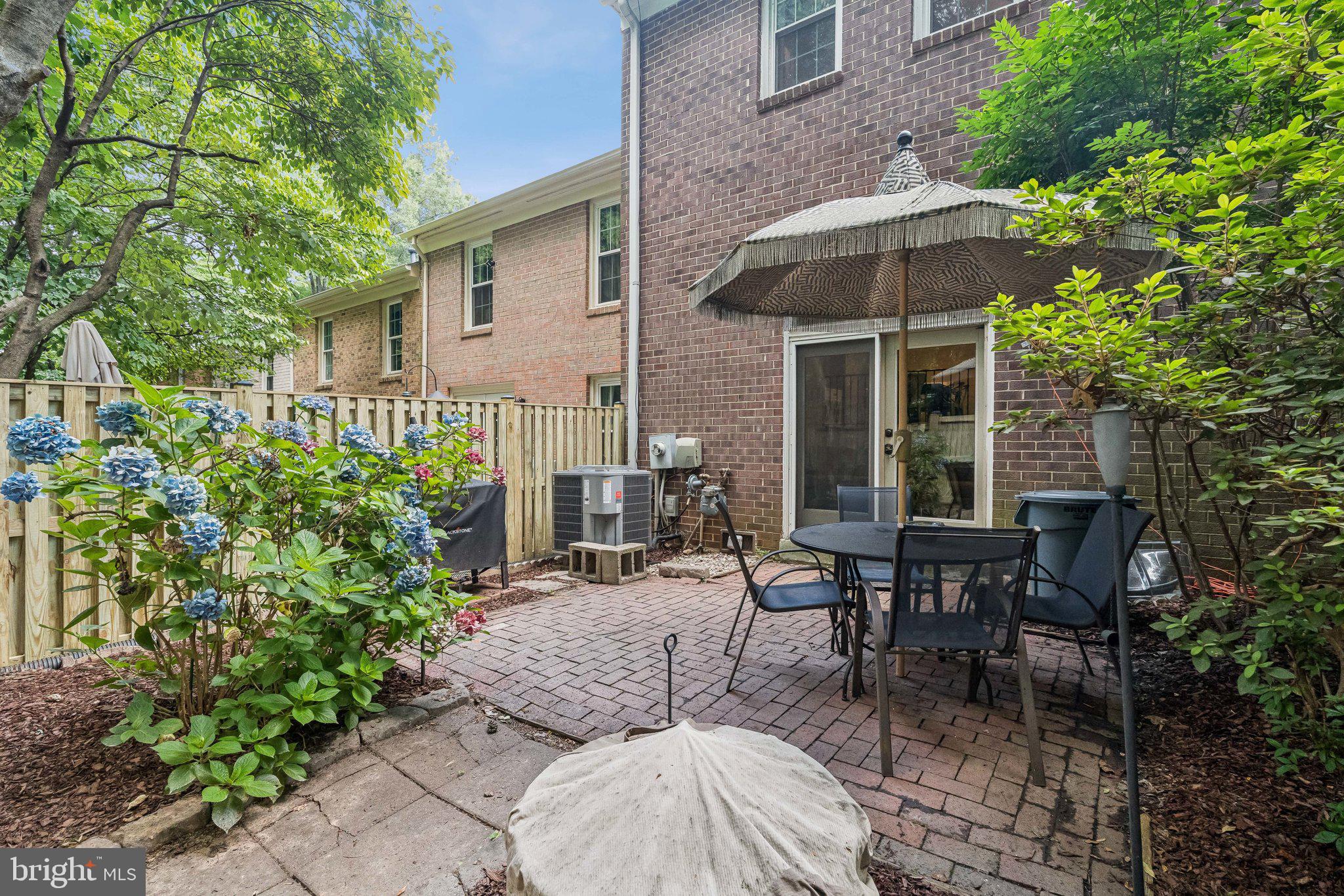 2408 Wanda Way Reston, VA 20191 - Photo 27 of 45 a view of a patio with table and chairs under an umbrella