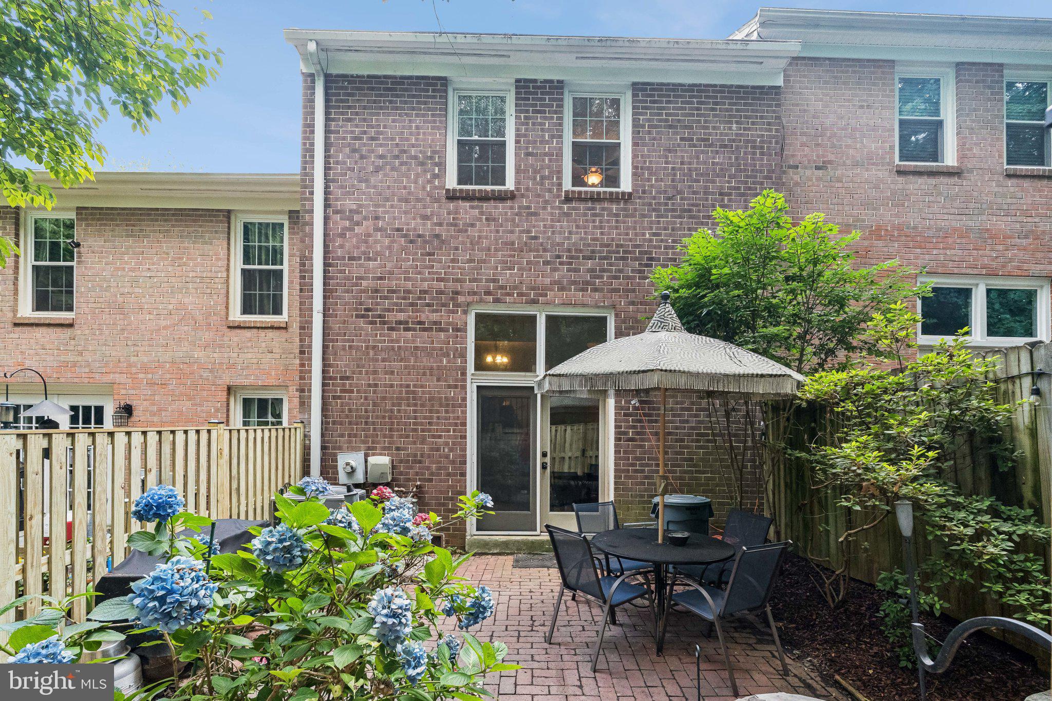 2408 Wanda Way Reston, VA 20191 - Photo 28 of 45 a front view of a house with an outdoor seating and yard