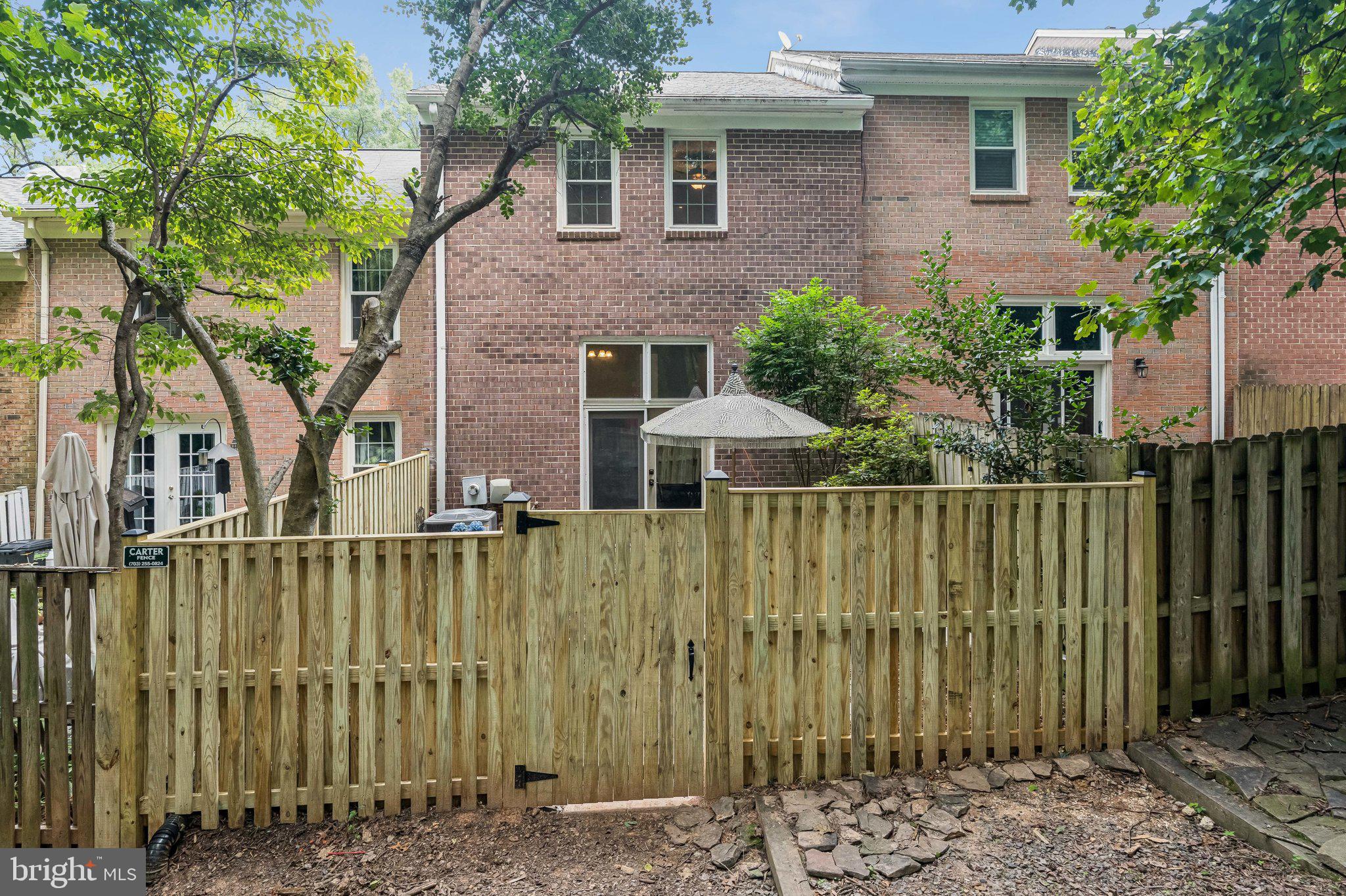 2408 Wanda Way Reston, VA 20191 - Photo 29 of 45 a view of a house with a wooden fence