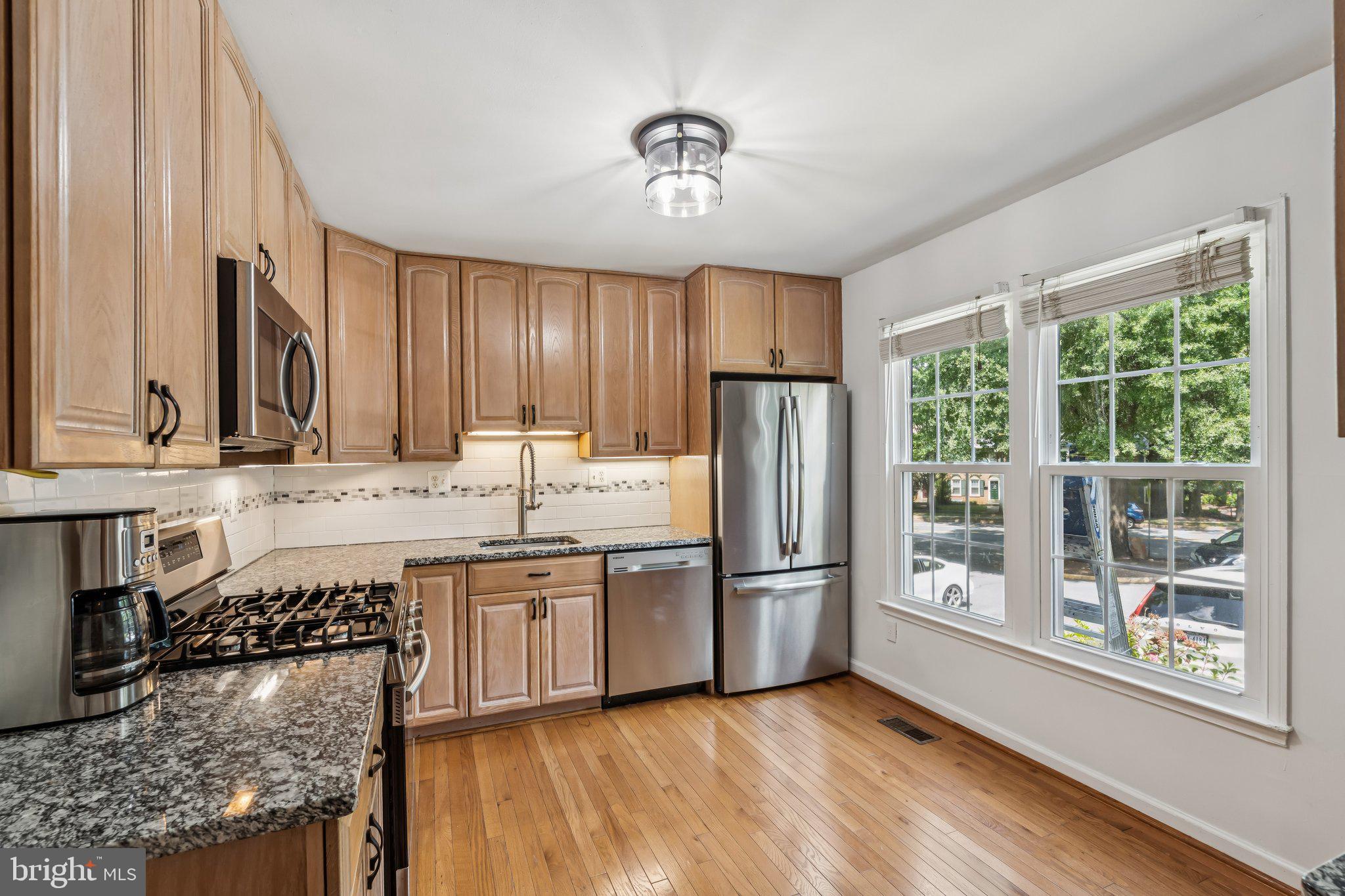 2408 Wanda Way Reston, VA 20191 - Photo 4 of 45 a kitchen with stainless steel appliances granite countertop a refrigerator and a sink