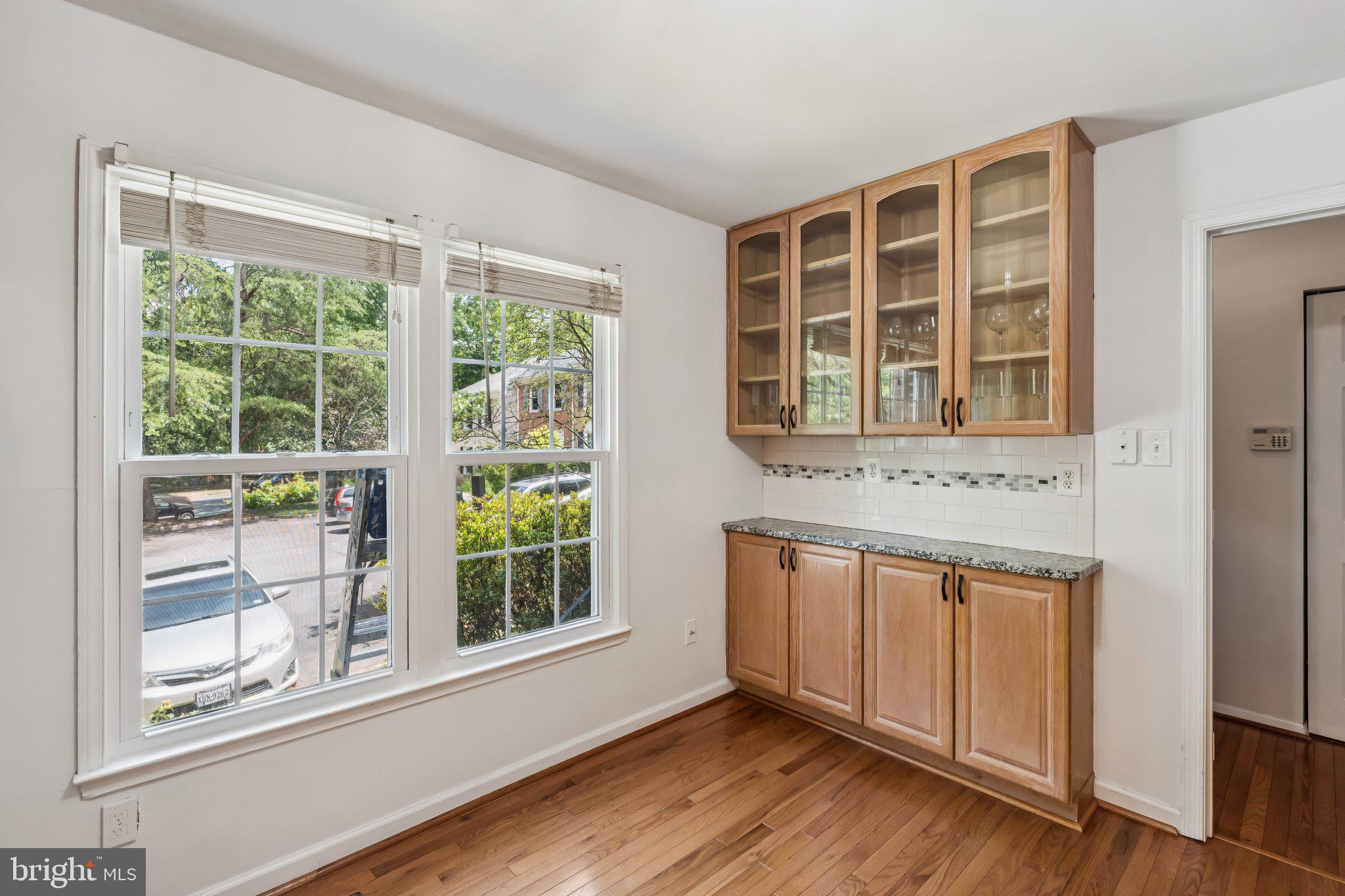 2408 Wanda Way Reston, VA 20191 - Photo 5 of 45 a view of an empty room with wooden floor and a window