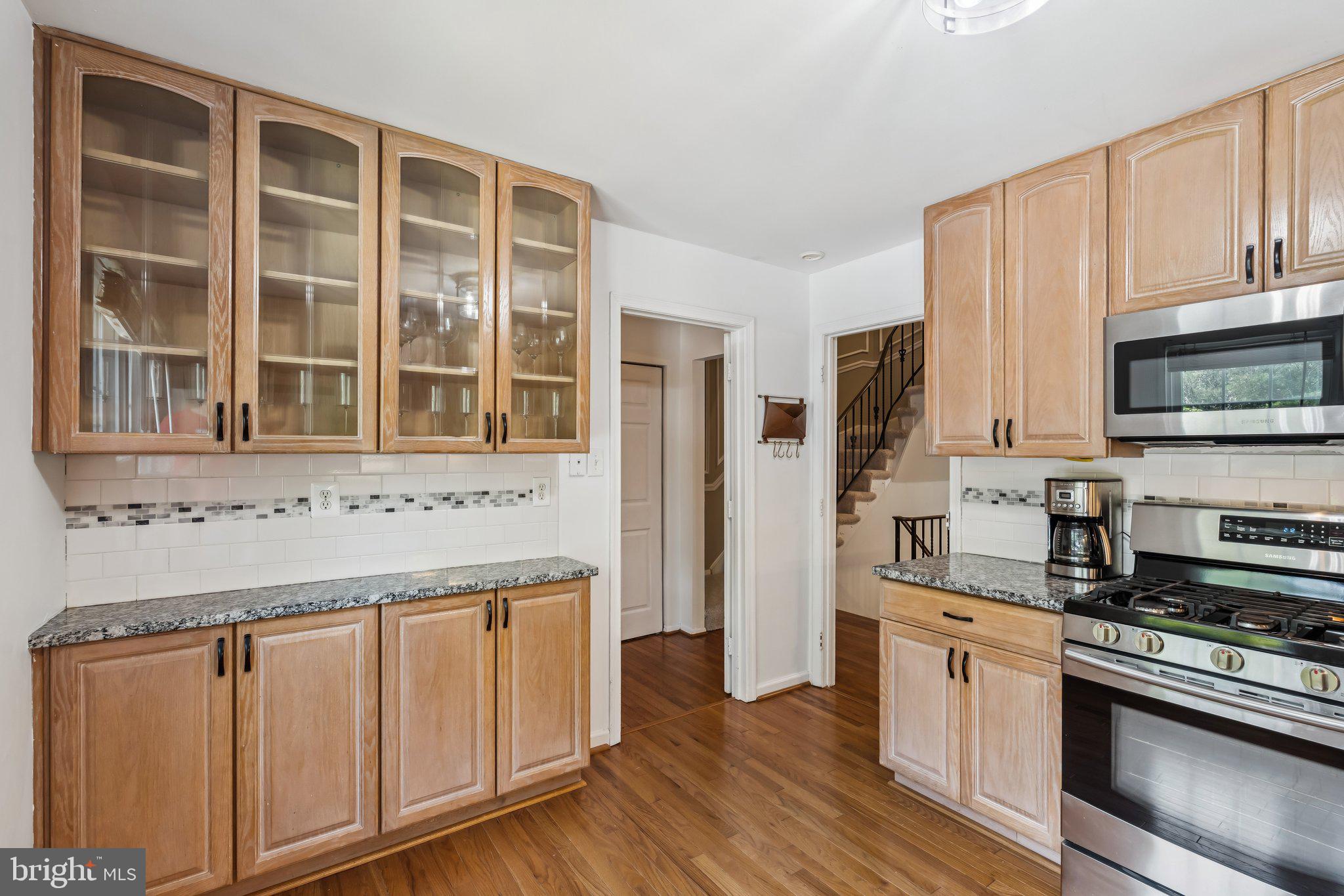 2408 Wanda Way Reston, VA 20191 - Photo 6 of 45 a kitchen with stainless steel appliances granite countertop a stove and a sink
