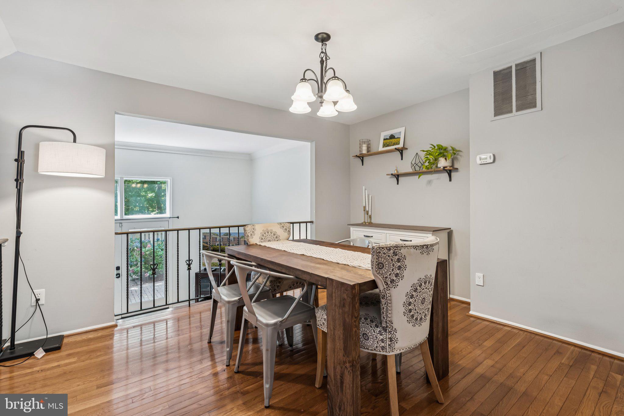 2408 Wanda Way Reston, VA 20191 - Photo 7 of 45 a view of a dining room with furniture window and wooden floor