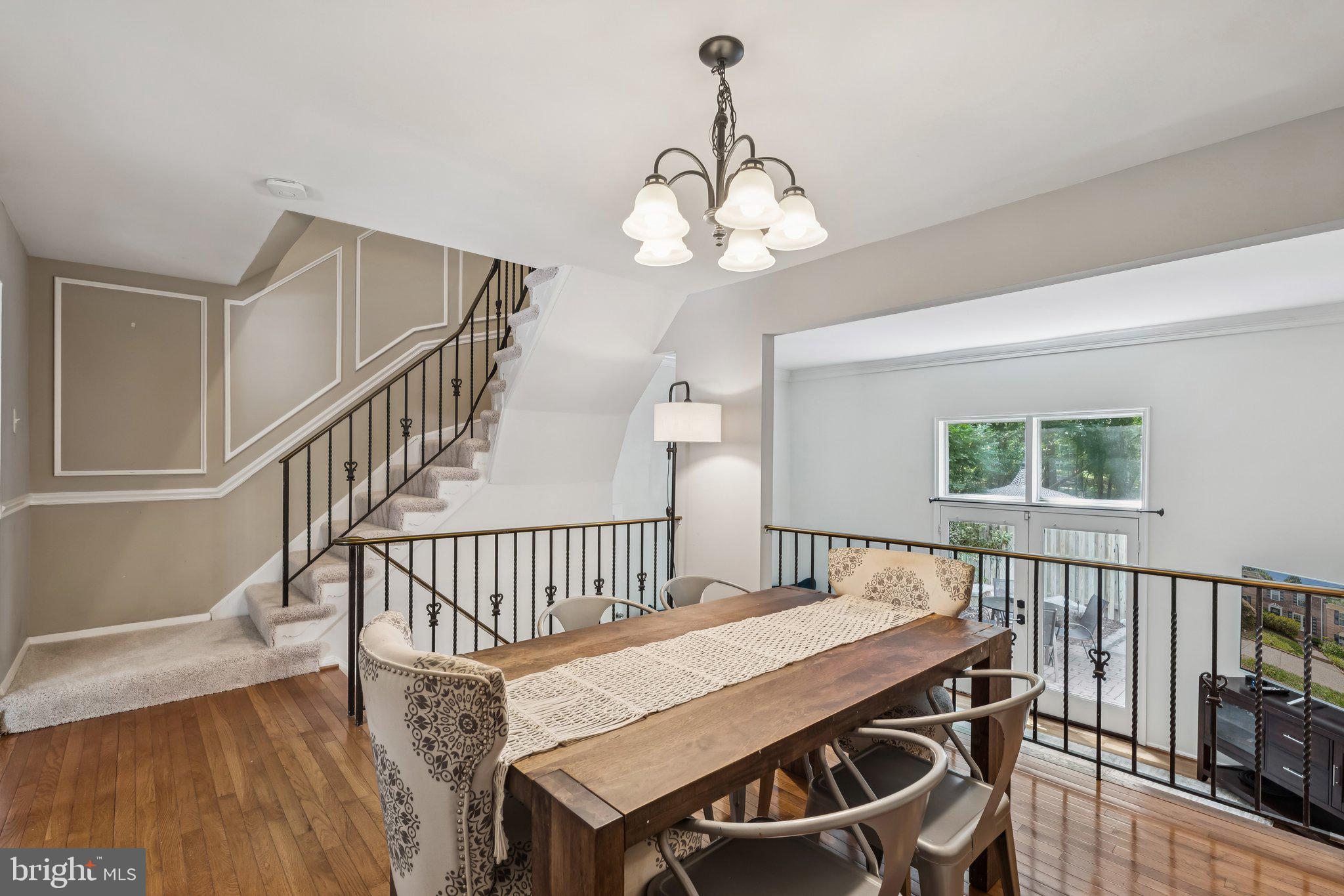 2408 Wanda Way Reston, VA 20191 - Photo 8 of 45 a view of a dining room with wooden floor windows and a chandelier