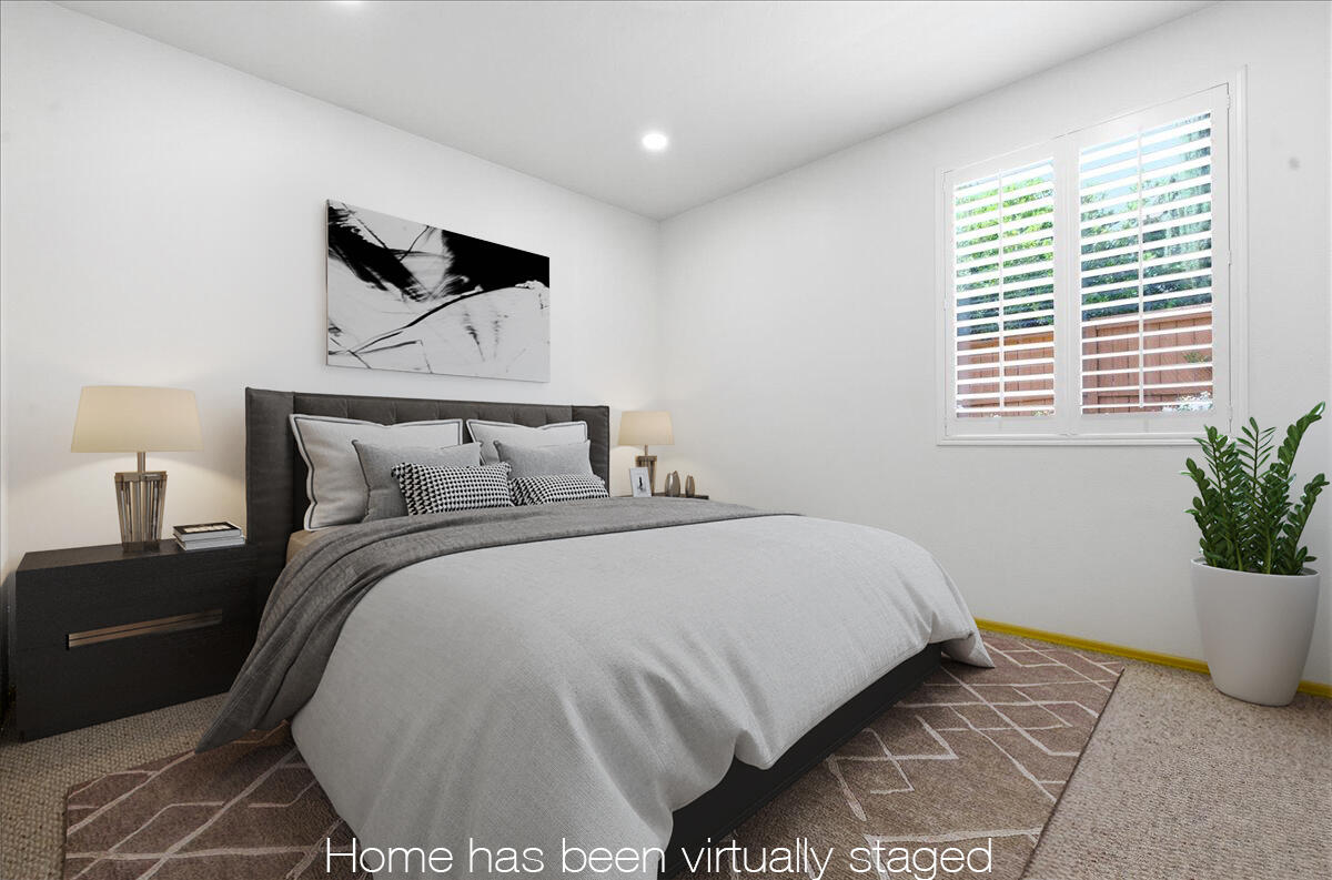 23732 Bella Vista Road Corona, CA 92883 - Photo 25 of 49 a bedroom with a bed and a potted plant