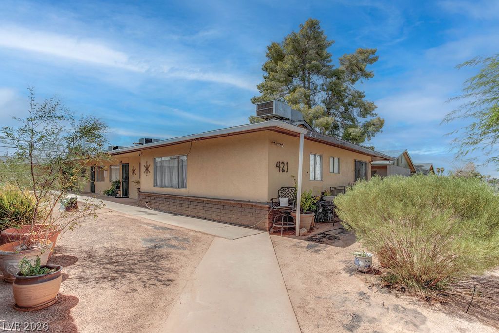 421 North Decatur Boulevard, Unit 2 Las Vegas, NV 89107 - Photo 3 of 21 A modest desert home with a clean facade and drought-resistant landscaping offers a tranquil retreat.