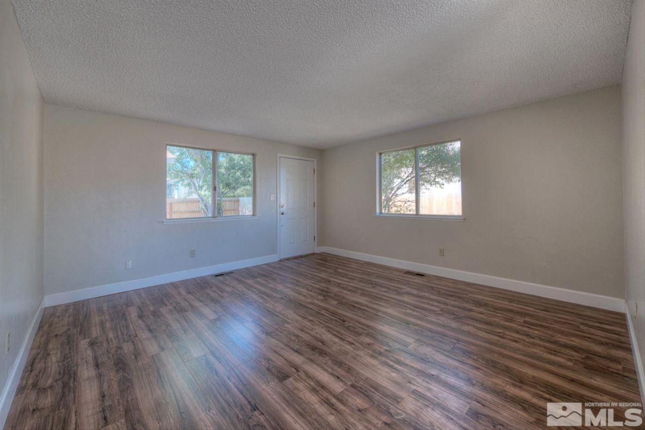 6815 Flower Street Reno, NV 89506 - Photo 3 of 25 a view of empty room with wooden floor and fan