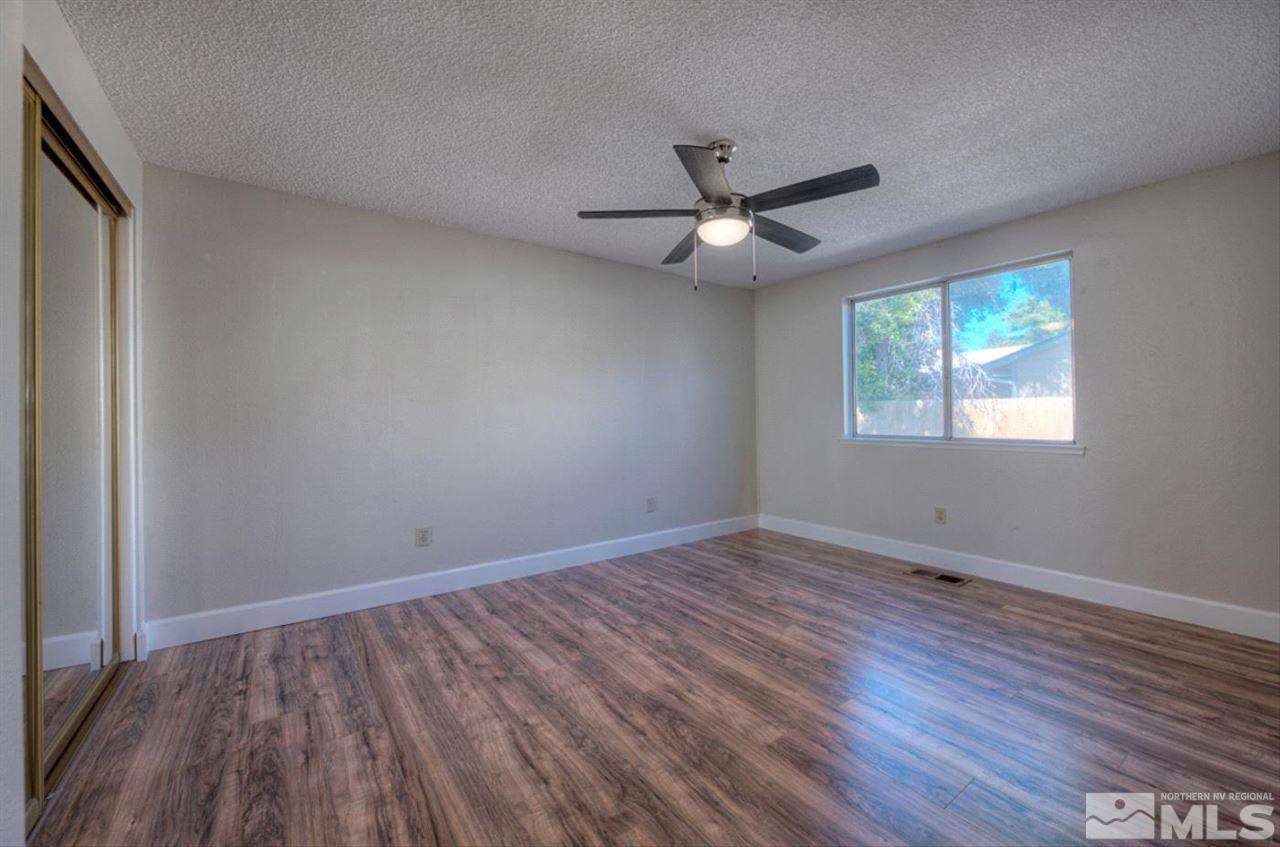 6815 Flower Street Reno, NV 89506 - Photo 7 of 25 wooden floor in an empty room with a window