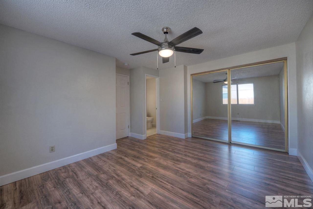 6815 Flower Street Reno, NV 89506 - Photo 8 of 25 a view of empty room with wooden floor and fan