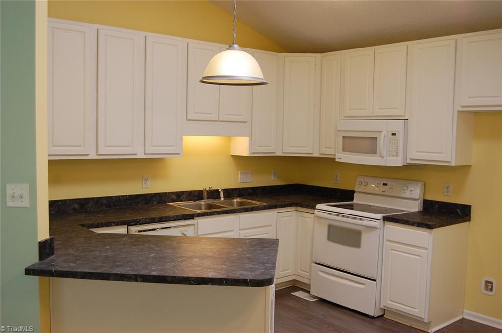 4301 Edgemore Road Greensboro, NC 27455 - Photo 10 of 19 42 inch cabinetry offers abundant storage. Lots of counter and prep space.