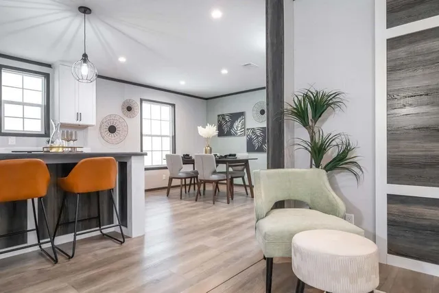 a living room with furniture potted plant and a table