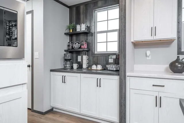 a kitchen with stainless steel appliances granite countertop a sink a stove and a refrigerator