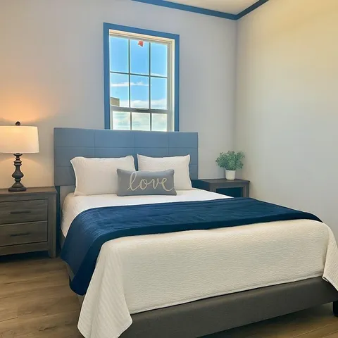 a bedroom with bed and window