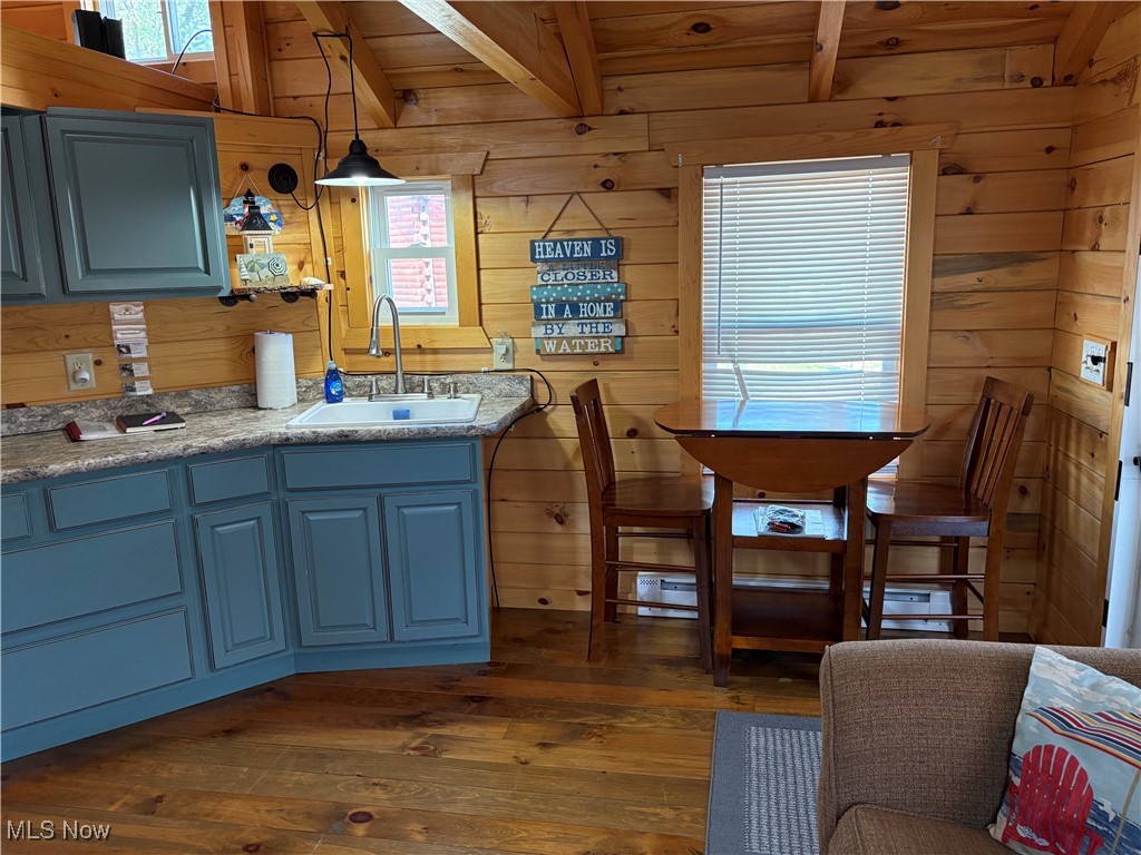 5919 Lake Road West, Unit 13 Ashtabula, OH 44004 - Photo 9 of 35 Dining room featuring wooden walls, finished wood floors, and a wooden ceiling with exposed beams
