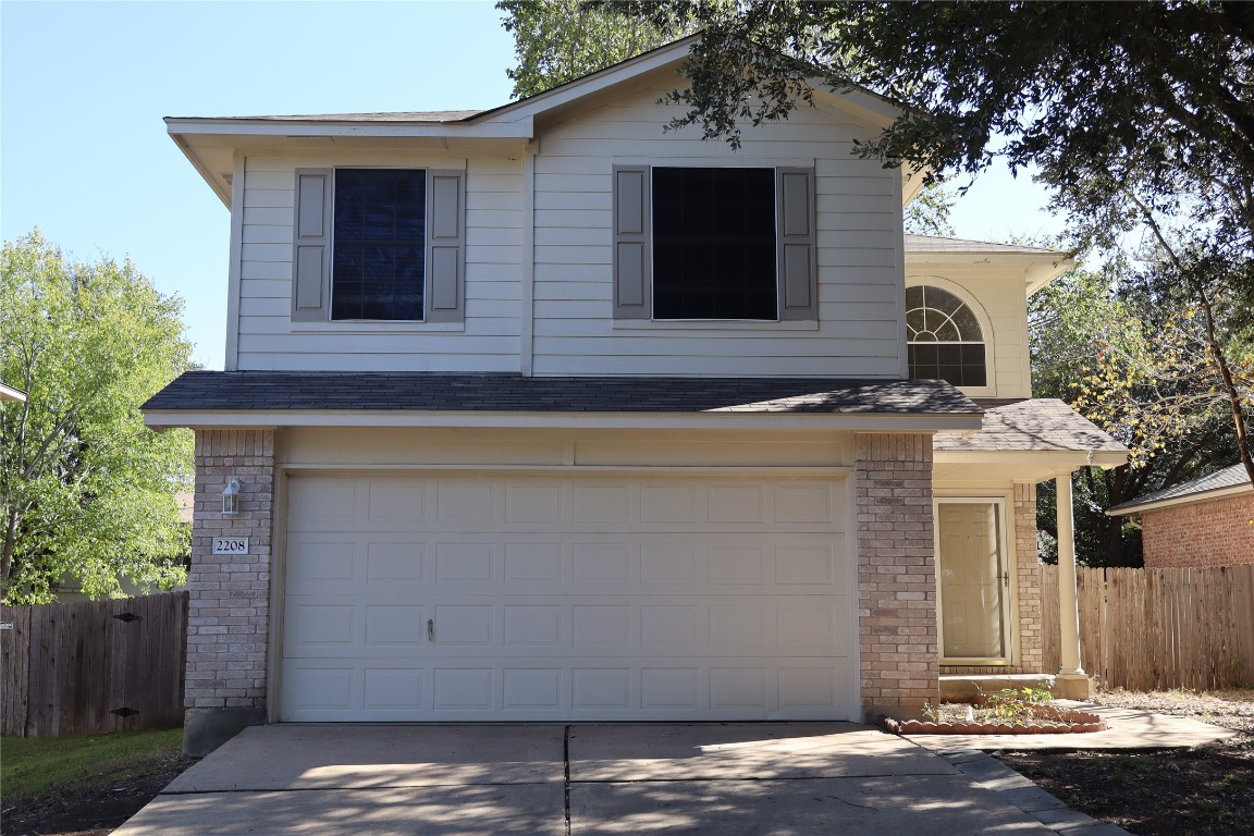 a front view of a house with garage