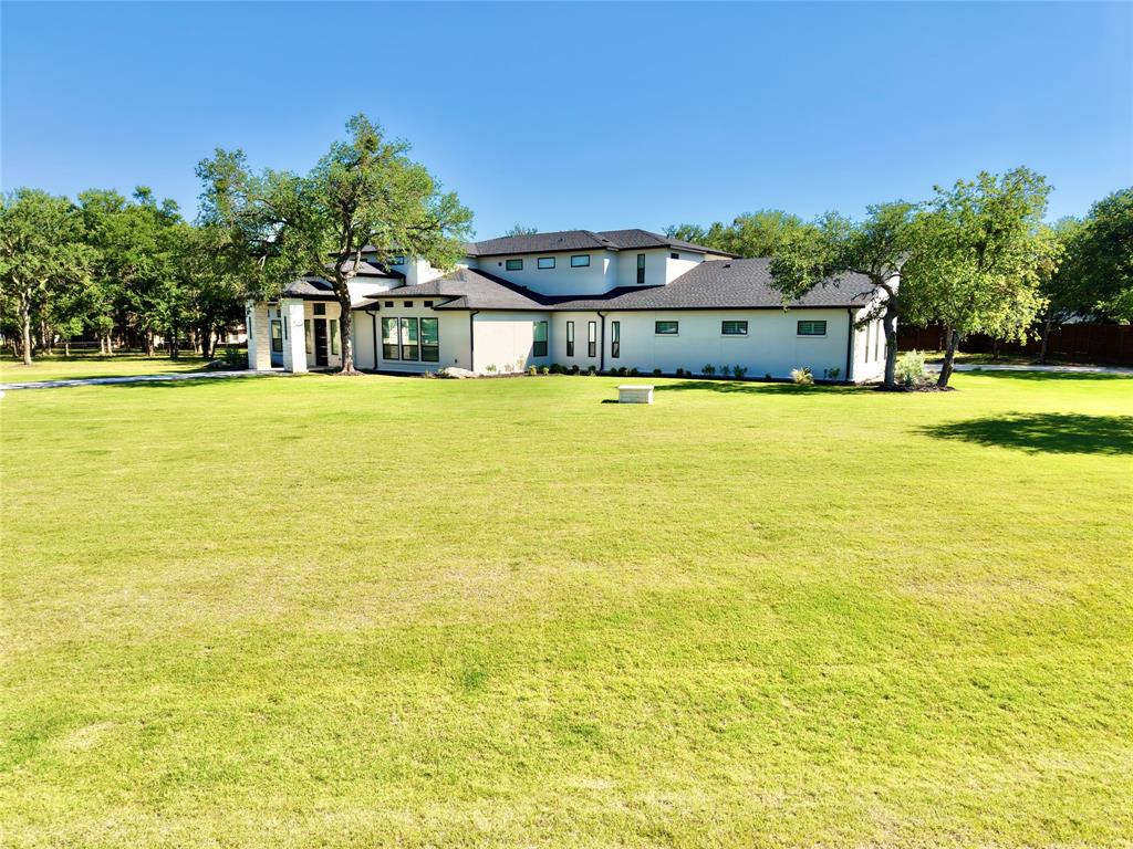 428 Squaw Creek Road Willow Park, TX 76087 - Photo 4 of 34 a large pool with lawn chairs under an umbrella