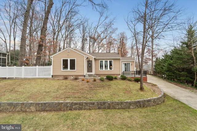 a view of a house with a yard and trees