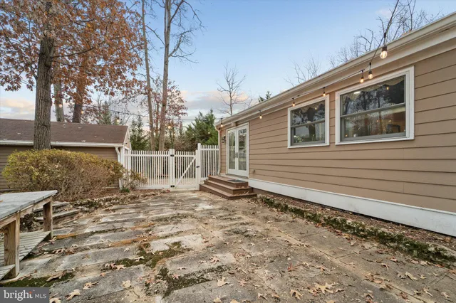 a backyard of a house with table and chairs