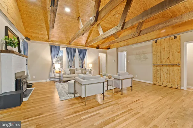 a living room with fireplace furniture and a wooden floor