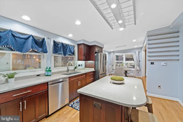a kitchen with a sink a stove and chairs