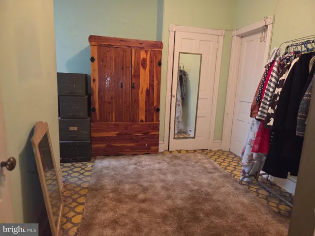 a view of walk in closet with clothes