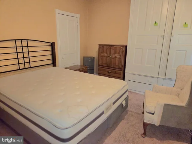 a bed sitting in a bedroom and table