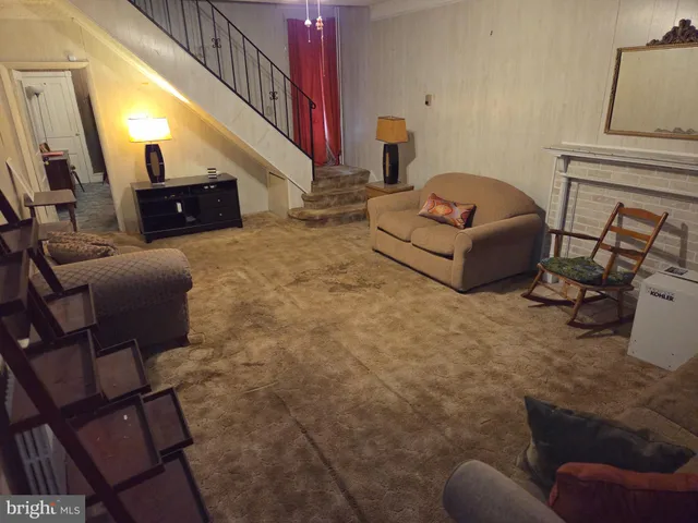 a living room with furniture and a mirror