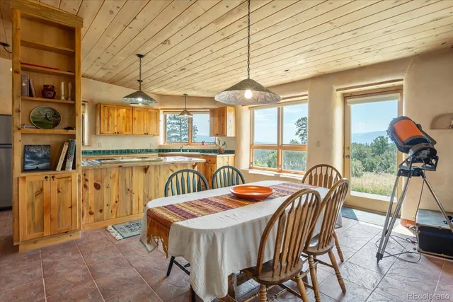 a view of a dining room with furniture wooden floor and chandelier