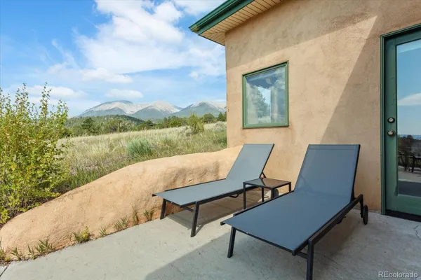 a view of a lush green forest with houses in the back