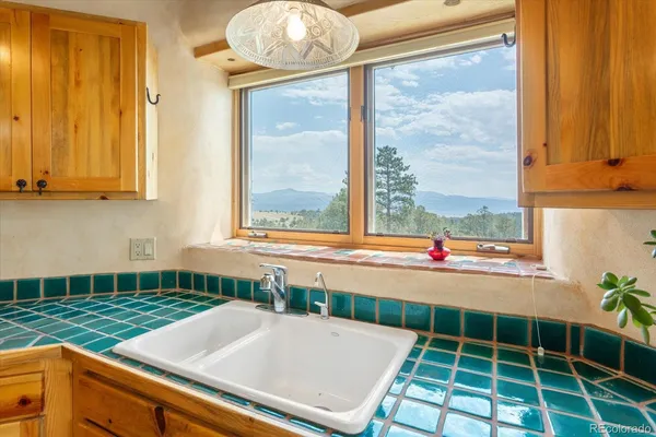 a view of a kitchen with a dining table and chairs