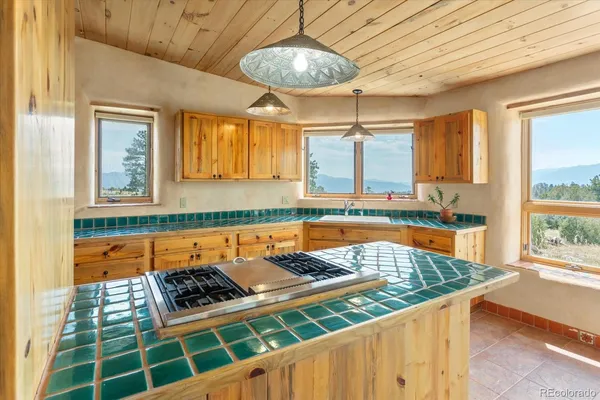 a kitchen with stove and cabinets