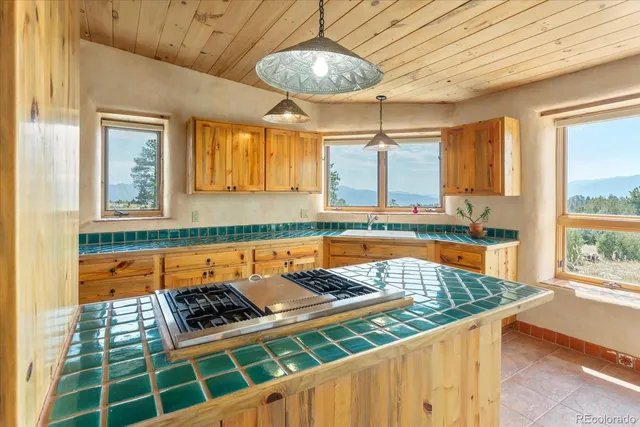 a kitchen with stove and cabinets