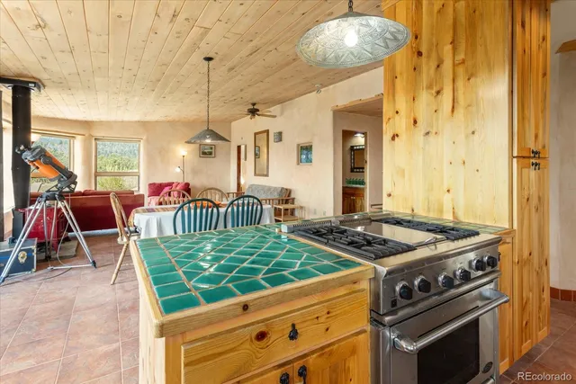 a kitchen with granite countertop a large window and a sink