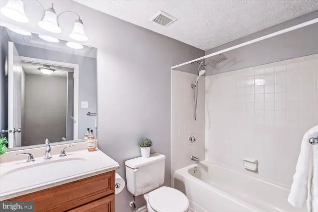 a bathroom with a sink toilet tub and shower
