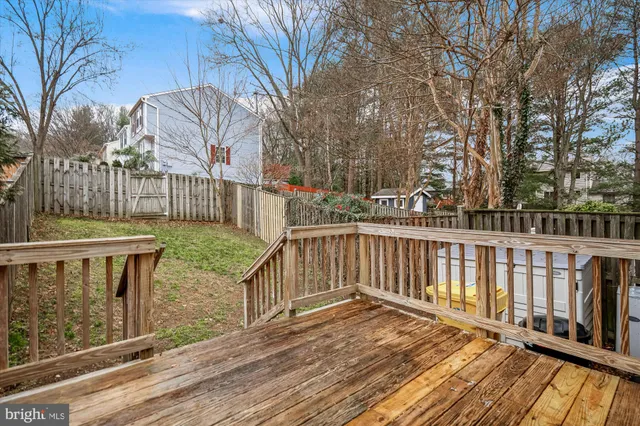 a view of a wooden deck with a yard