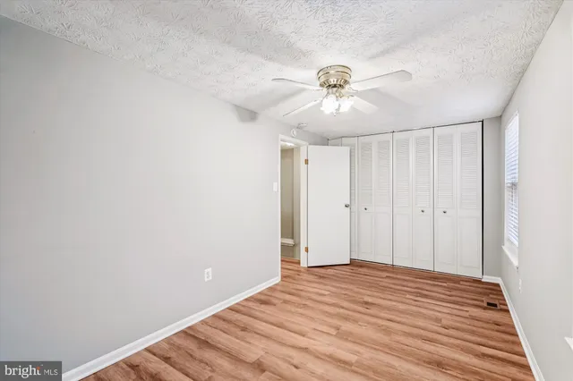 a view of a big room with wooden floor and closet
