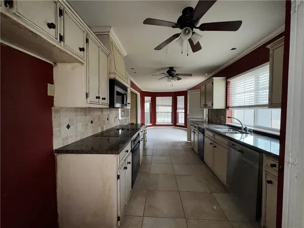 a view of a livingroom with a ceiling fan and window