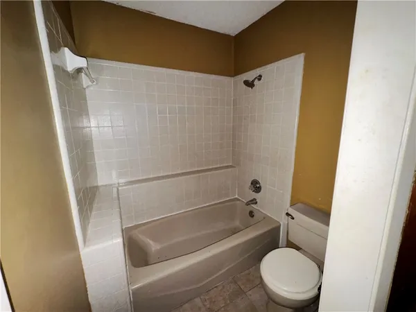 a view of empty room with ceiling fan