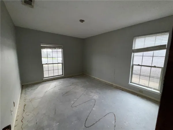 a view of an empty room with large windows