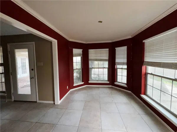 an empty room with a empty space and windows