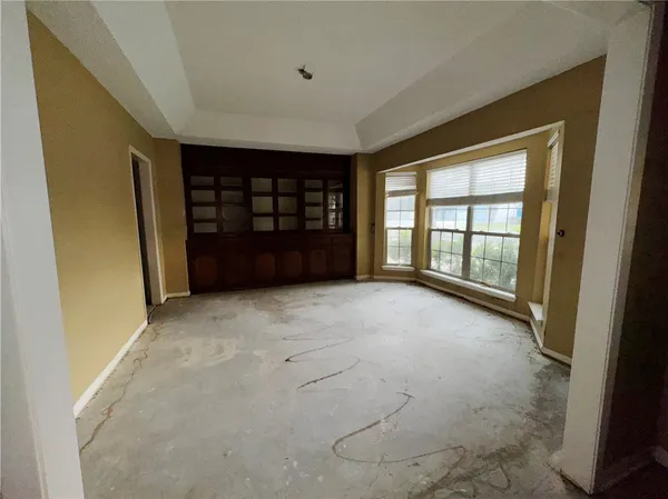 a view of a house with a yard and large trees