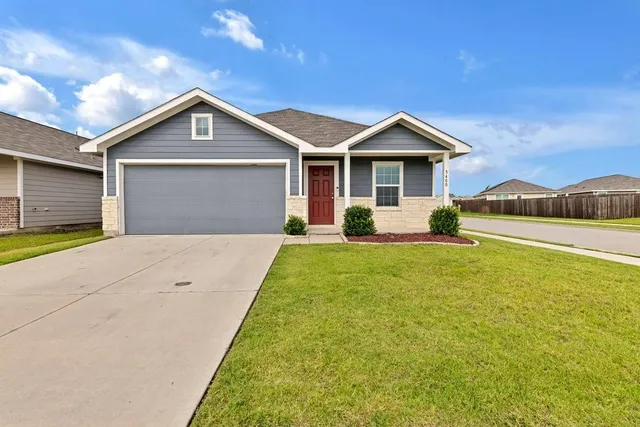 a front view of a house with yard