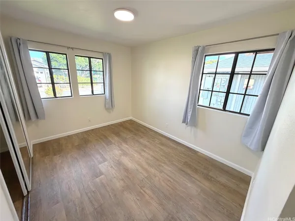 an empty room with wooden floor and door