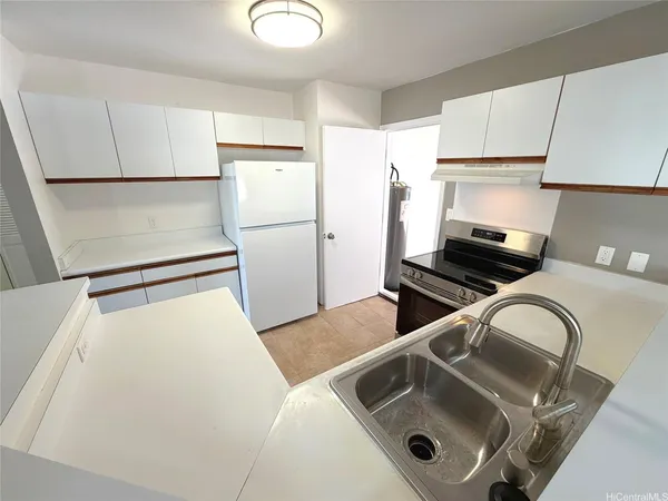 a kitchen with a refrigerator sink and stove